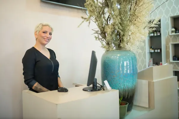 Jess Calder smiling behind the front desk